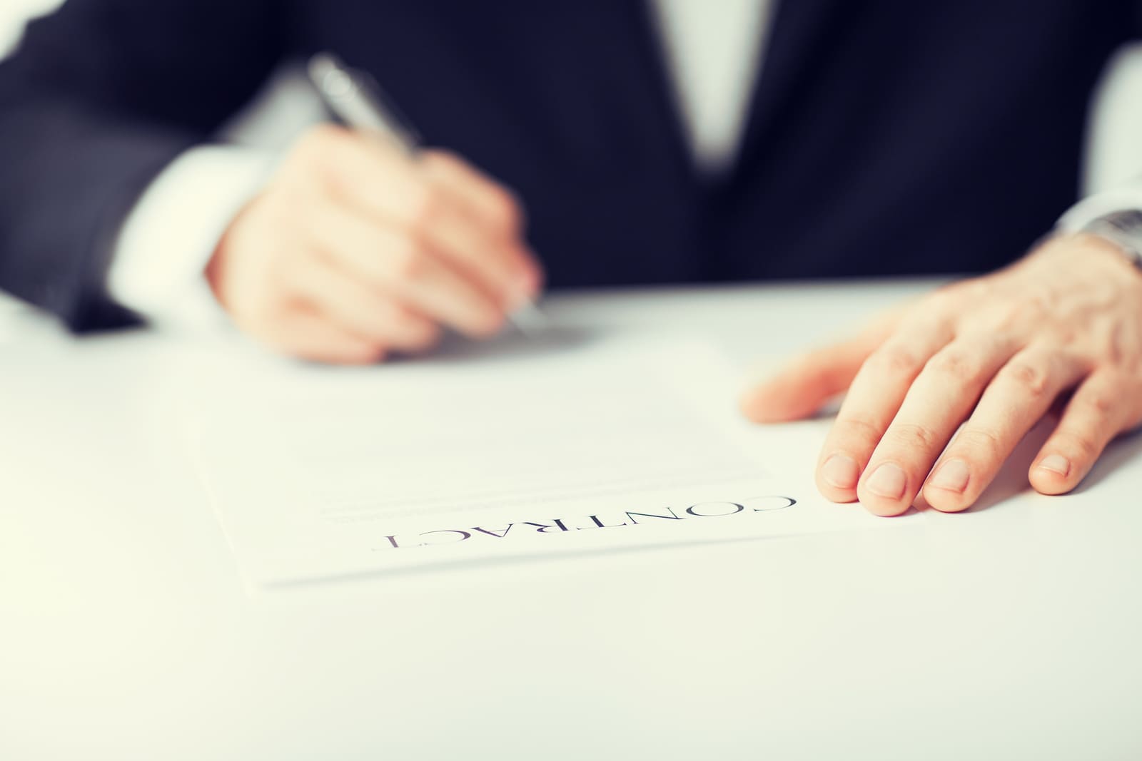 man signing a cleaning contract for small business